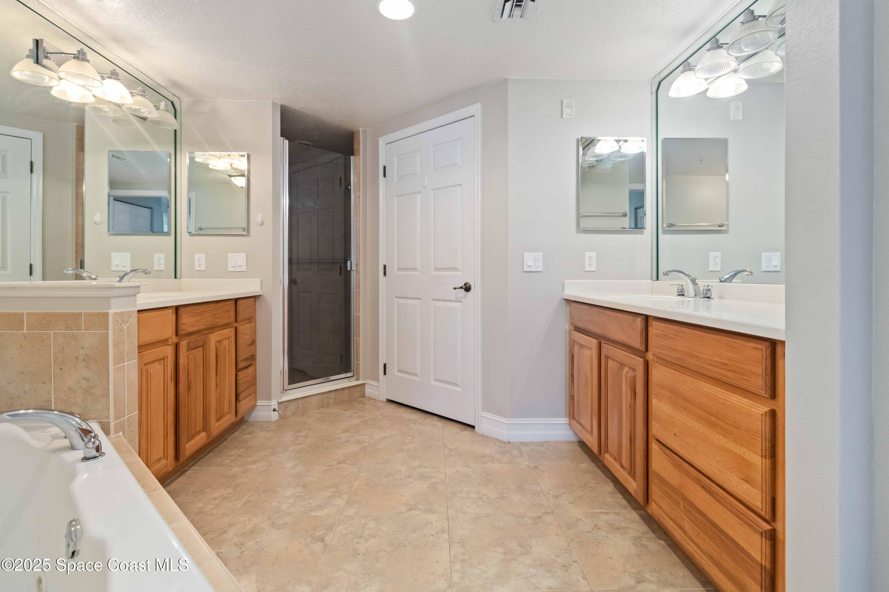 134 Starboard Lane, Unit 404 Merritt Island, FL 32953 - Photo 19 of 30 a bathroom with a sink and a mirror