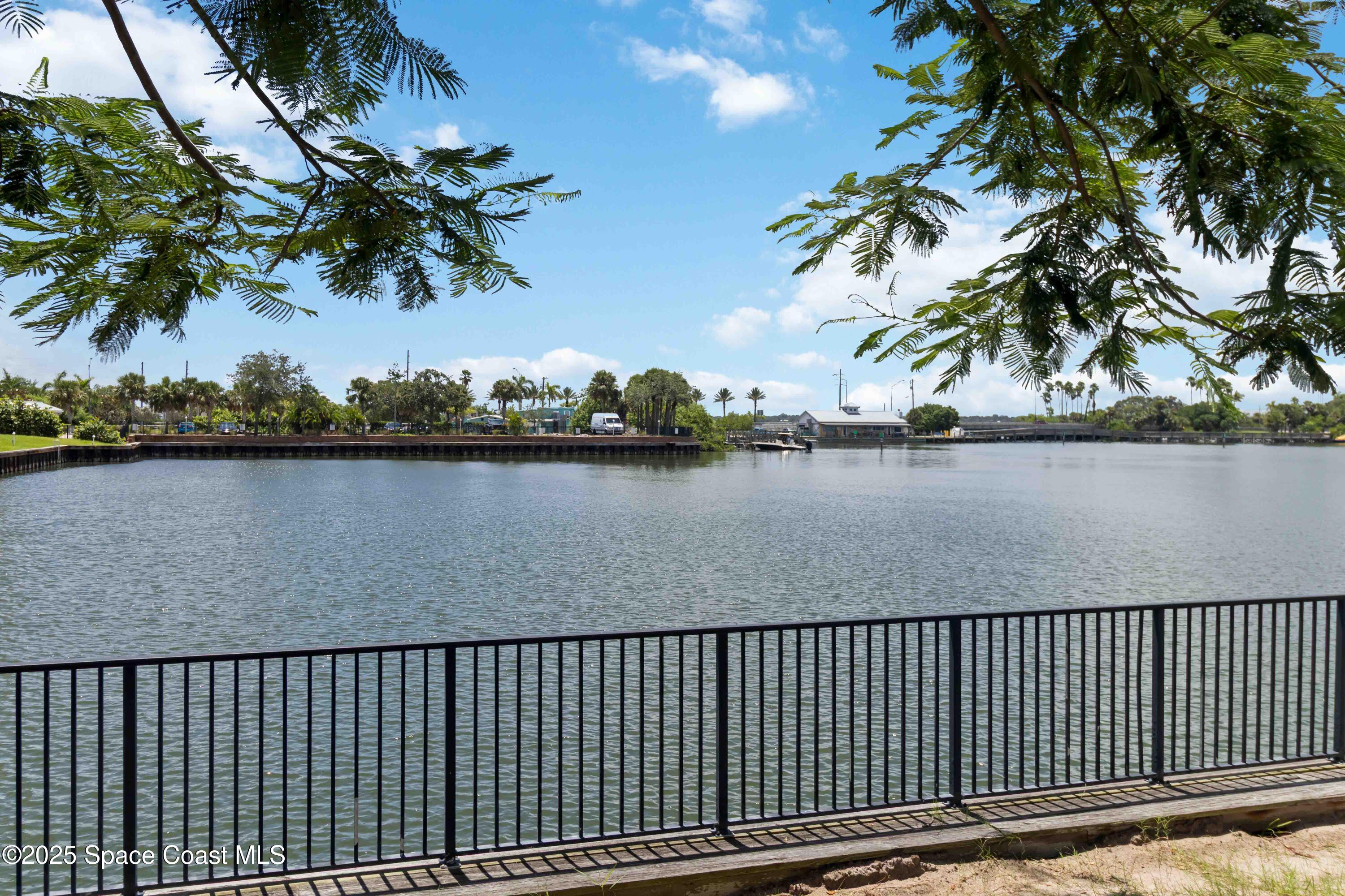 134 Starboard Lane, Unit 404 Merritt Island, FL 32953 - Photo 27 of 30 a view of a roof deck with potted plants and palm trees