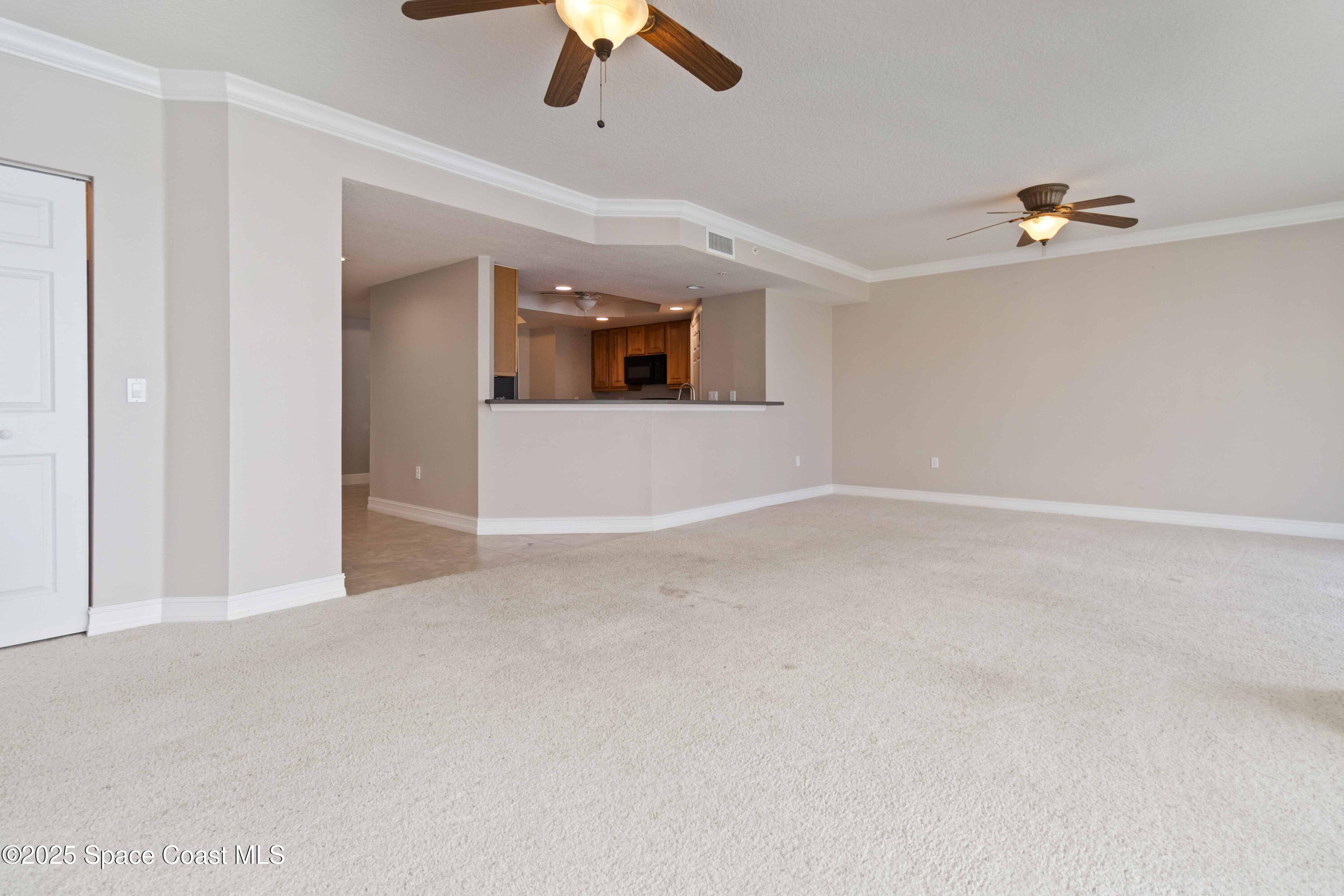 134 Starboard Lane, Unit 404 Merritt Island, FL 32953 - Photo 8 of 30 an empty room with chandelier fan