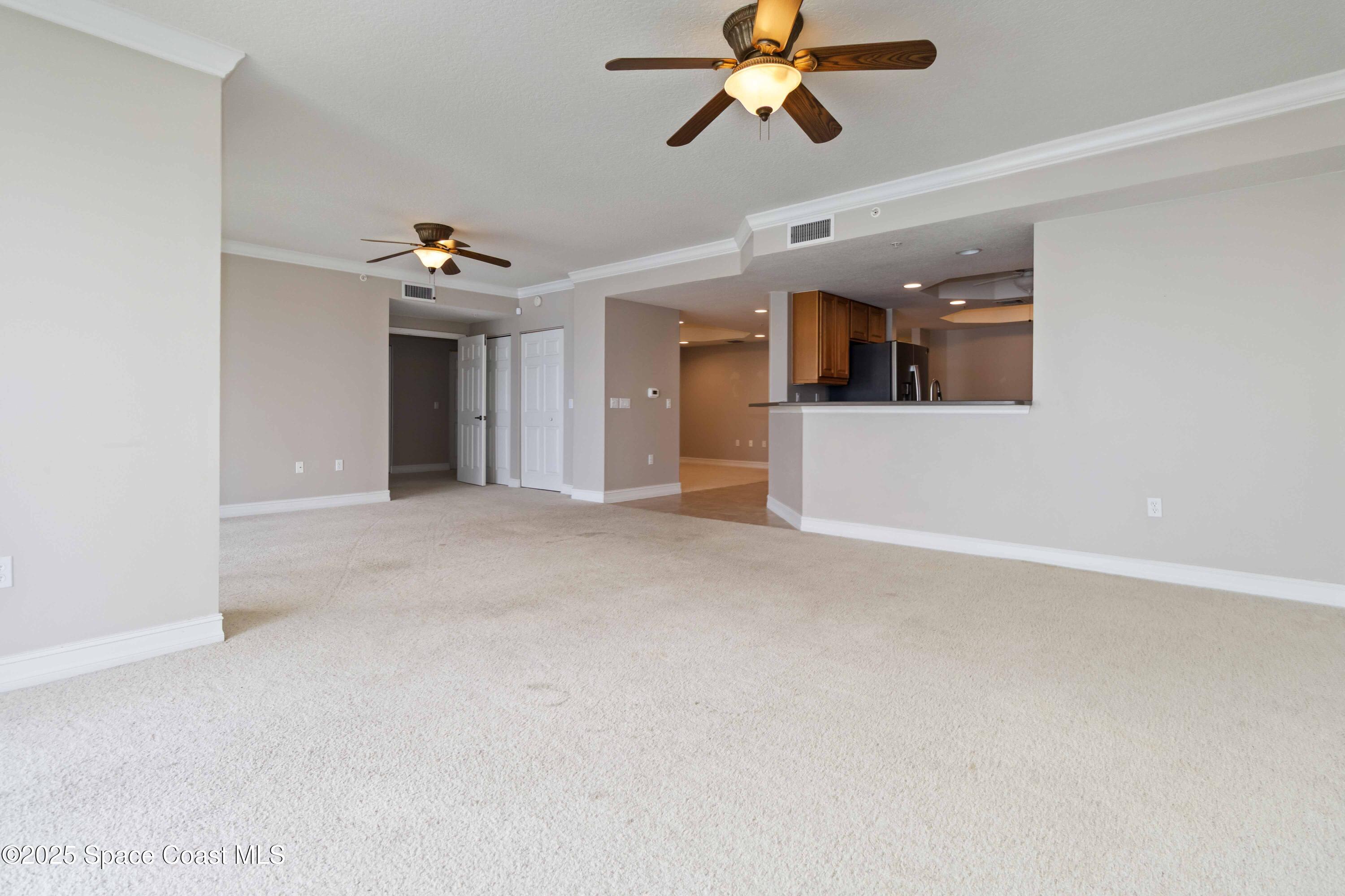 134 Starboard Lane, Unit 404 Merritt Island, FL 32953 - Photo 9 of 30 a view of a livingroom with a ceiling fan and window