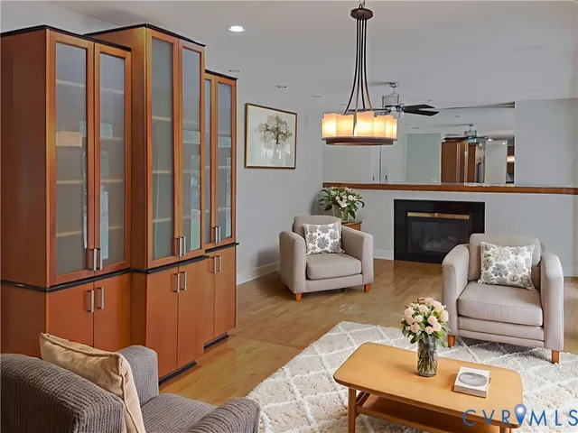 a living room with furniture and a chandelier