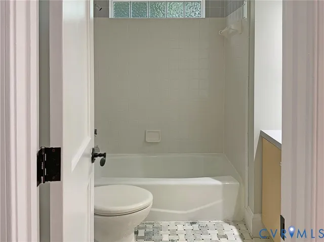 a view of a room with an empty space and window