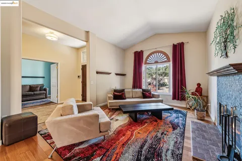 a dining room with furniture a rug and a window