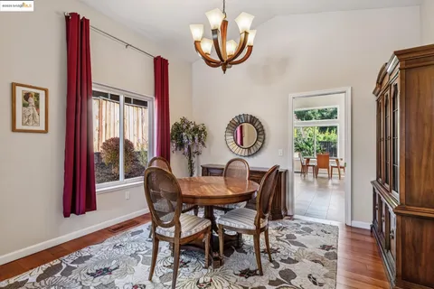 a view of a livingroom with furniture wooden floor and windows