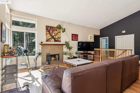 a kitchen with stainless steel appliances granite countertop a stove a sink a microwave dining table and chairs