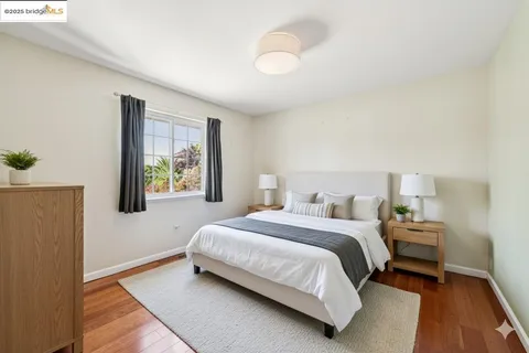 a workspace with furniture wooden floor and a window