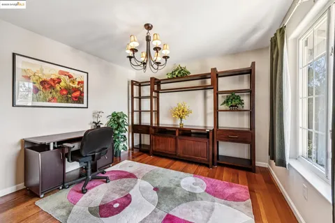 a bedroom with furniture and a large window