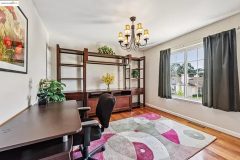 a bathroom with a granite countertop sink mirror vanity and toilet