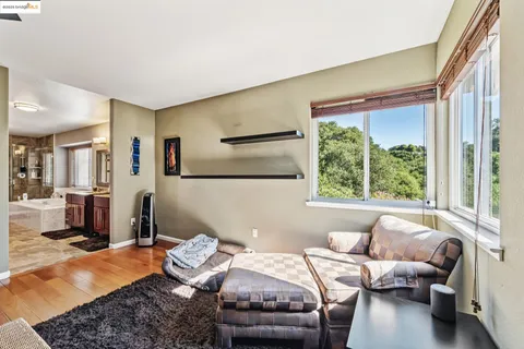 a room with a wooden floor and a window