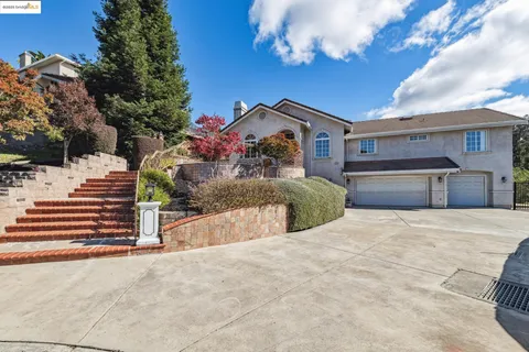 a view of a house with a yard and garage