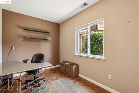 a balcony with wooden floor outdoor seating and yard in the back