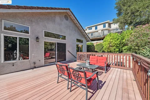 a view of a patio with couches under an umbrella