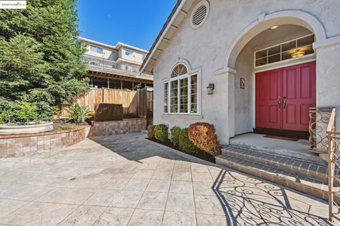 a living room with furniture a fireplace and a chandelier