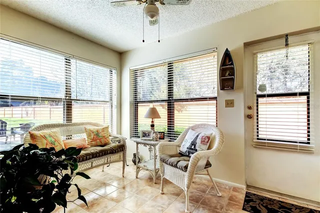 a living room with furniture and floor to ceiling windows