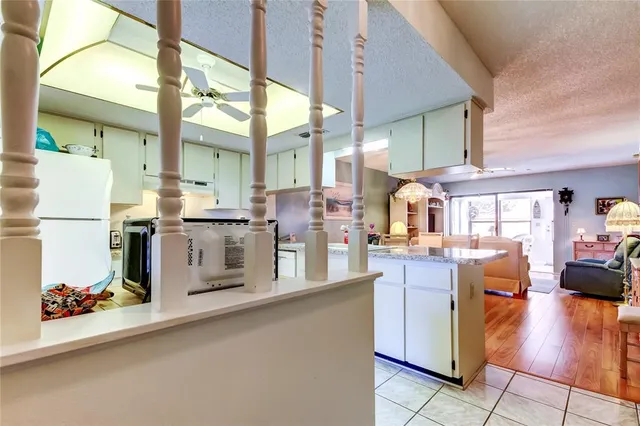 a kitchen with stainless steel appliances kitchen island granite countertop a stove and a sink