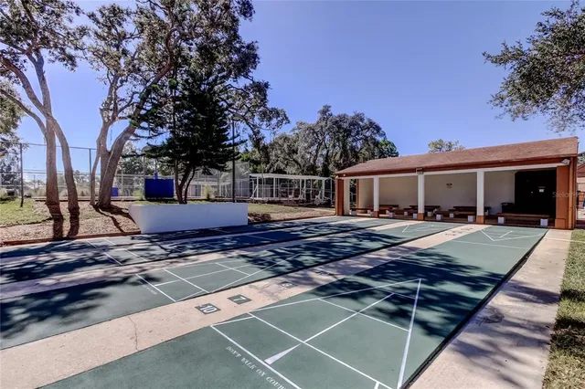 a front view of house with yard and trees in the background