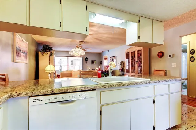 a kitchen with stainless steel appliances granite countertop a sink and a cabinets