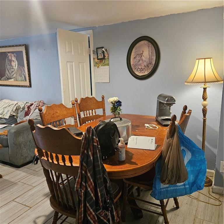4880 Ben Hill Road Atlanta, GA 30349 - Photo 11 of 48 a view of a dining room with furniture and chandelier