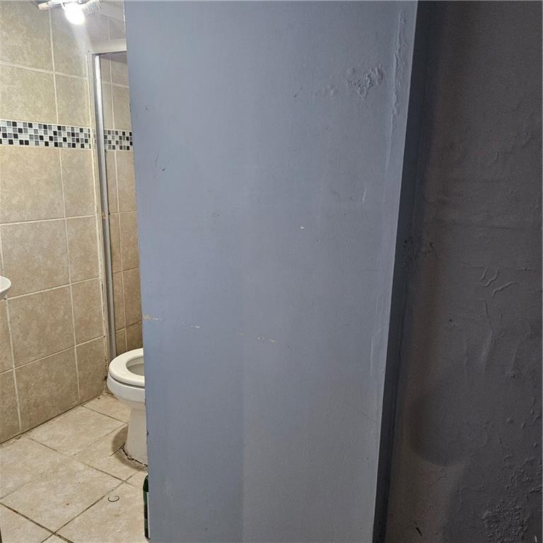 4880 Ben Hill Road Atlanta, GA 30349 - Photo 13 of 48 a bathroom with a toilet and a shower