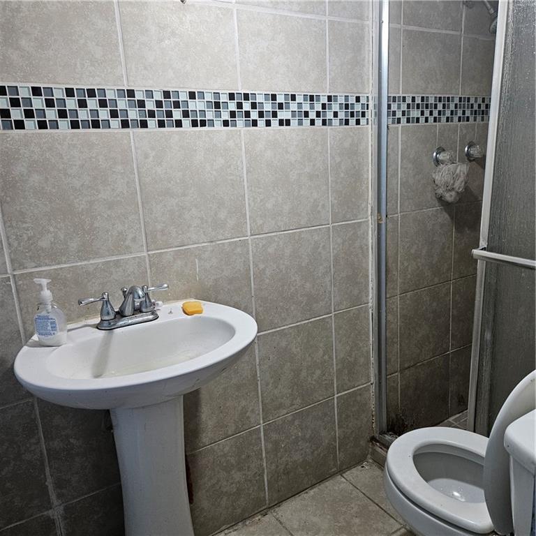 4880 Ben Hill Road Atlanta, GA 30349 - Photo 15 of 48 a bathroom with a sink a toilet and shower