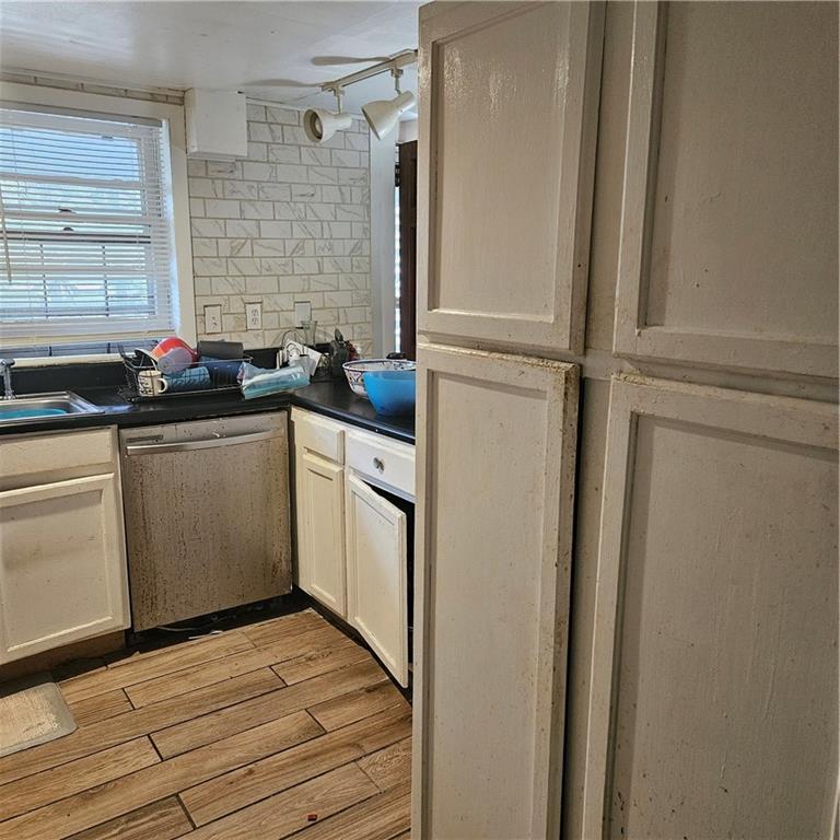 4880 Ben Hill Road Atlanta, GA 30349 - Photo 21 of 48 a kitchen with a sink cabinets stainless steel appliances and a window