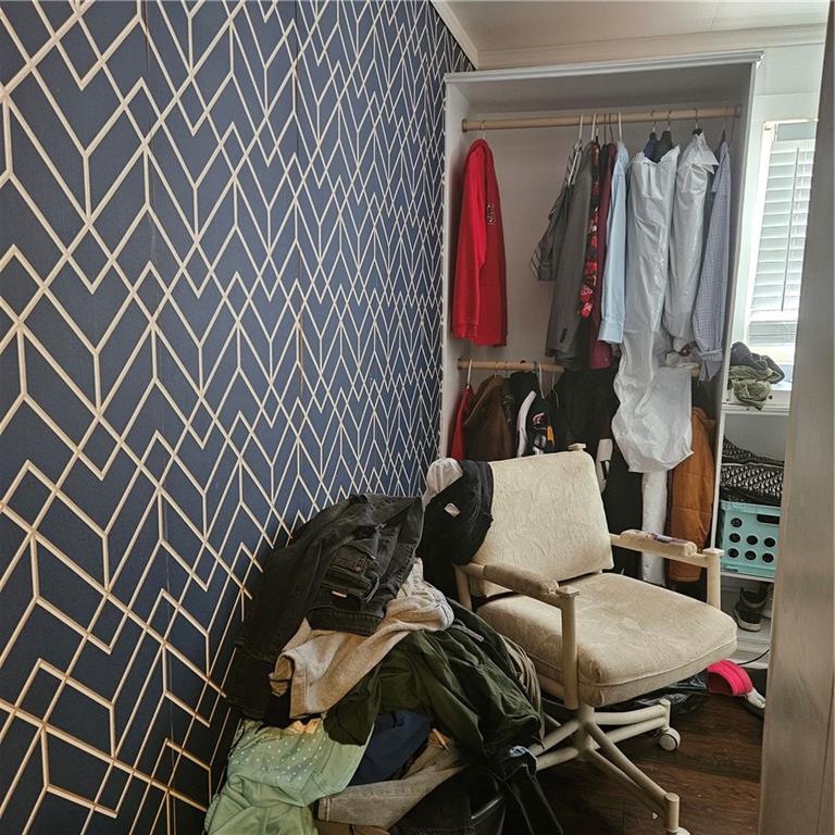 4880 Ben Hill Road Atlanta, GA 30349 - Photo 30 of 48 a view of walk in closet with clothes and shoes