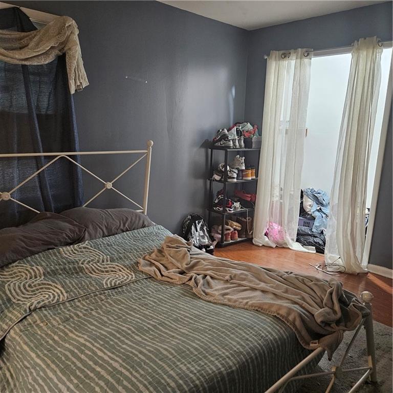 4880 Ben Hill Road Atlanta, GA 30349 - Photo 33 of 48 a bedroom with a bed and a closet