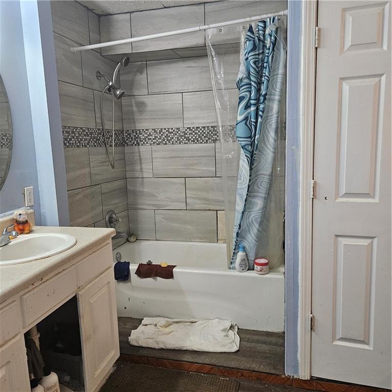 4880 Ben Hill Road Atlanta, GA 30349 - Photo 35 of 48 a bathroom with a sink and a bathtub