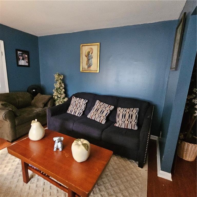 4880 Ben Hill Road Atlanta, GA 30349 - Photo 5 of 48 a living room with furniture and a wooden floor