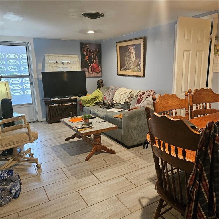 4880 Ben Hill Road Atlanta, GA 30349 - Photo 10 of 48 a living room with furniture and a flat screen tv