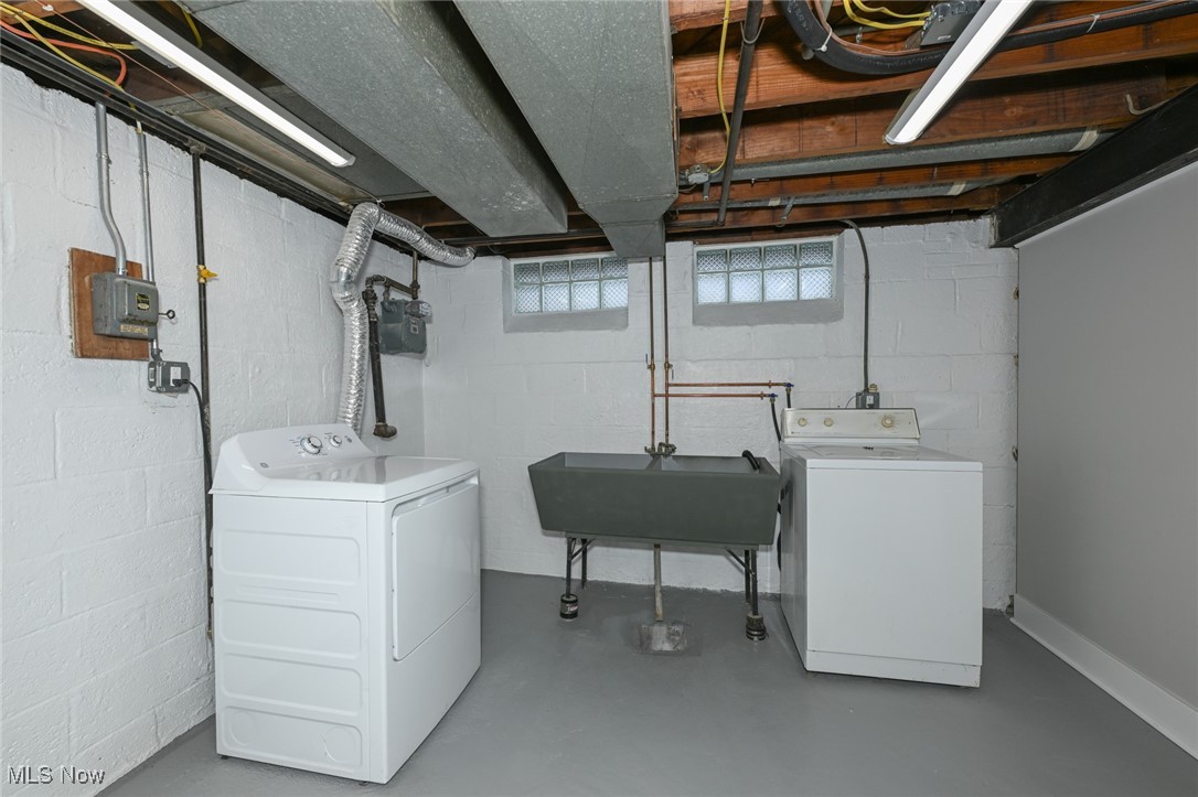 1571 Lander Road Cleveland, OH 44124 - Photo 35 of 39 Washroom featuring finished concrete floors and washing machine and clothes dryer