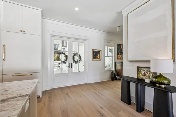a view of entryway and hall with wooden floor
