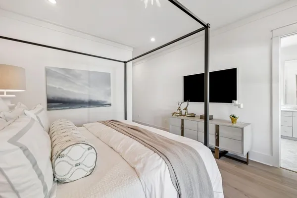 a spacious bedroom with two beds and a flat screen tv