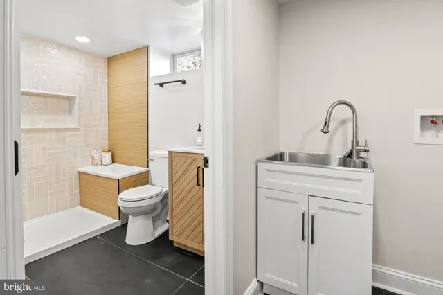 a bathroom with a toilet sink and mirror