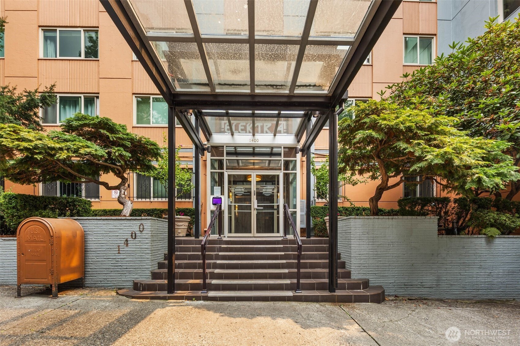 a view of a porch with a table and chairs and potted plants