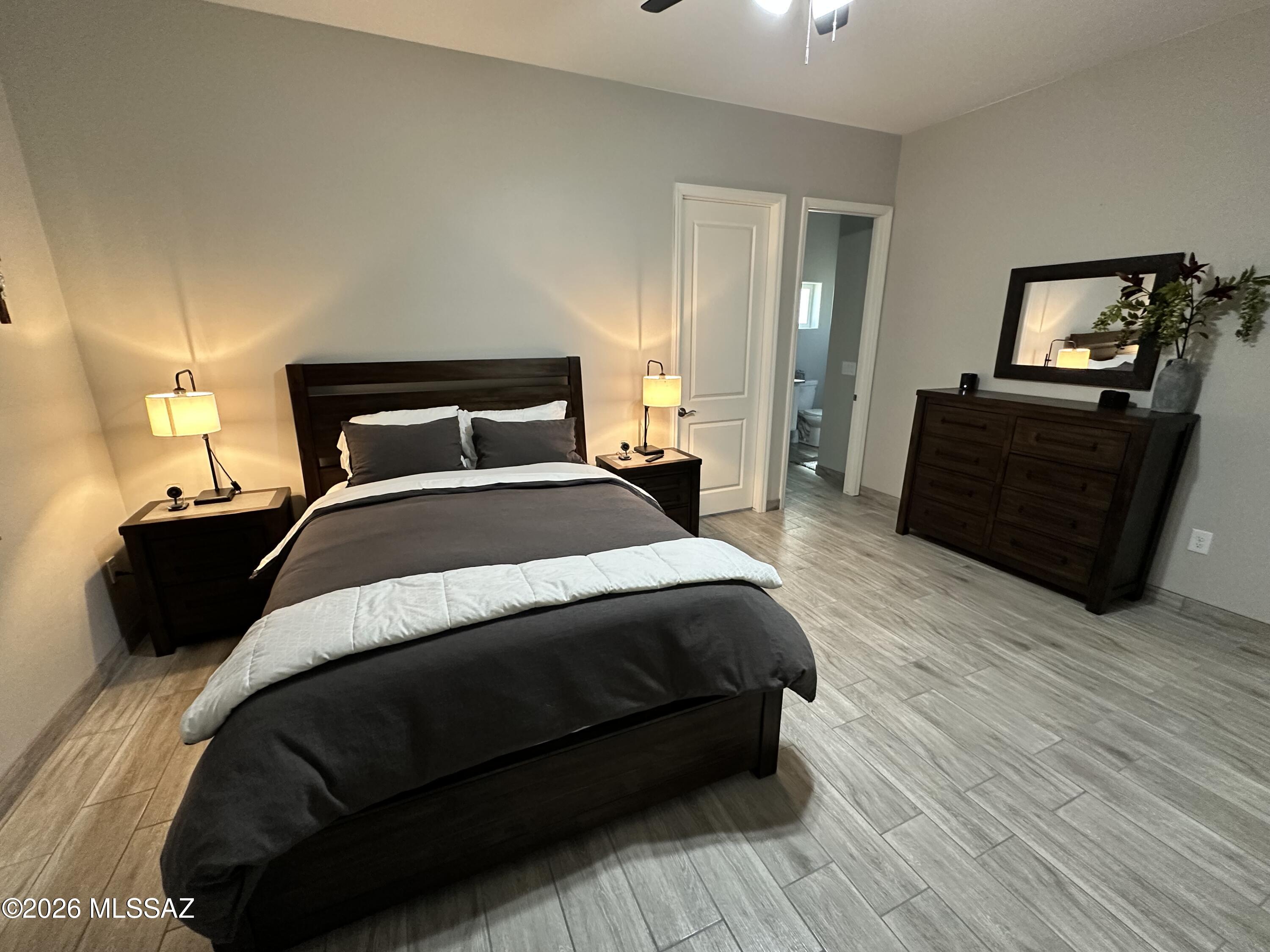 117 Ver Patria Rio Rico, AZ 85648 - Photo 19 of 28 a bedroom with a bed and wooden floor