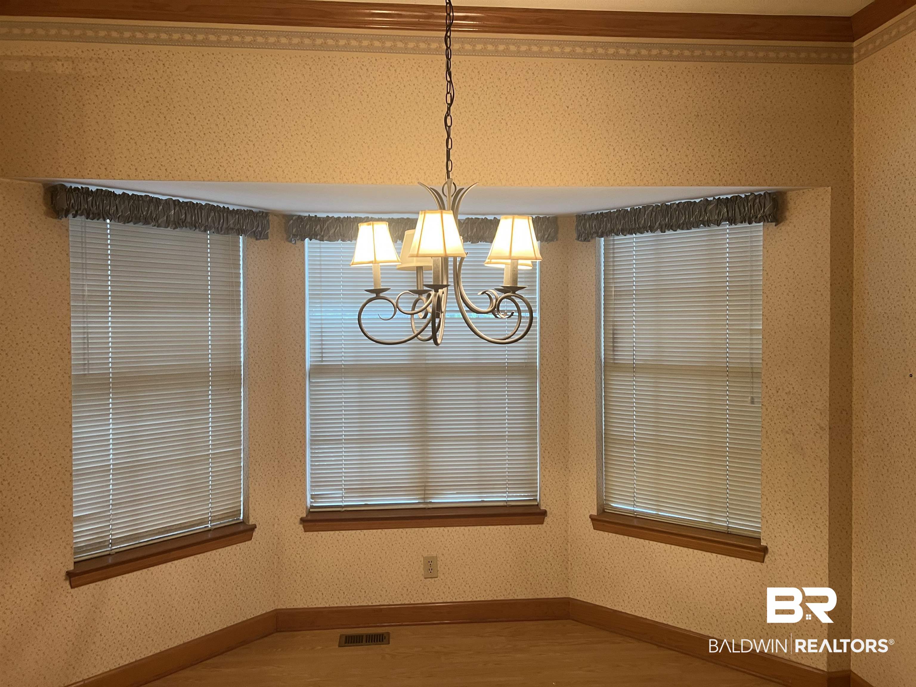 295 Norwood Road Monroeville, AL 36460 - Photo 7 of 32 Unfurnished dining area featuring a chandelier, wood finished floors, and baseboards