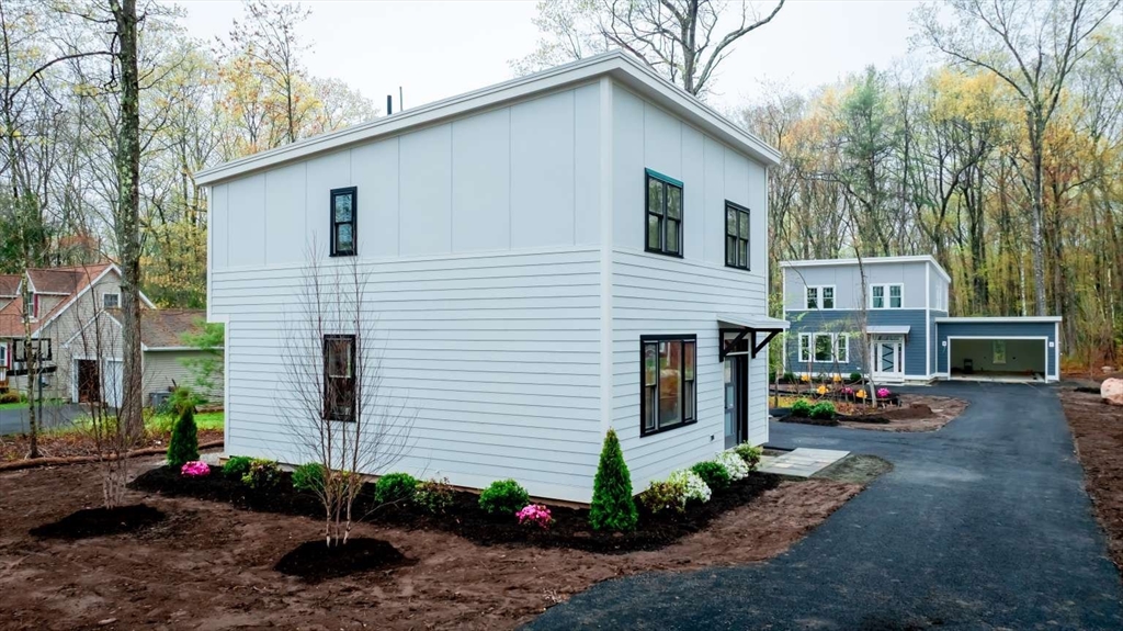811 Burts Pit Road Northampton, MA 01062 - Photo 2 of 10 a view of a white house with a yard and large tree