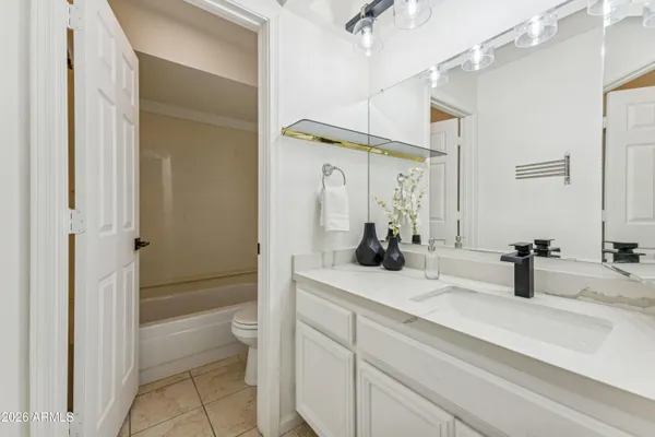 a view of an empty room with a ceiling fan