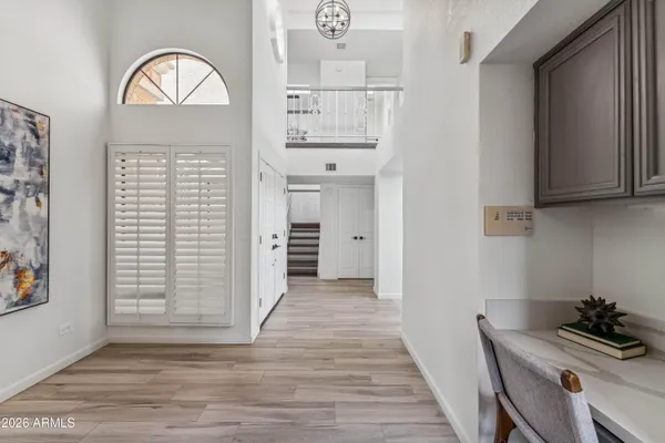 a view of a hallway with chandelier