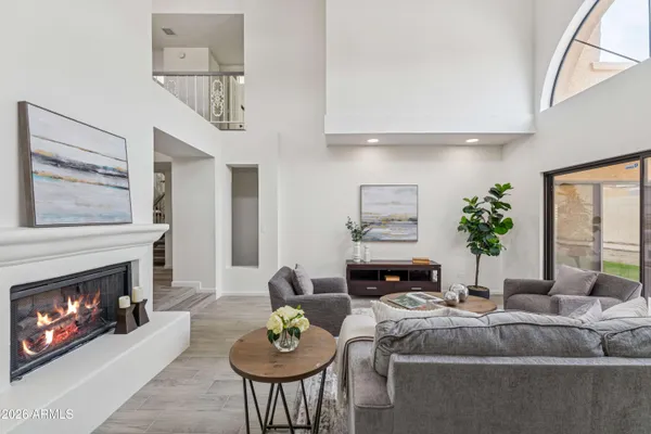 a living room with furniture a chandelier and a window