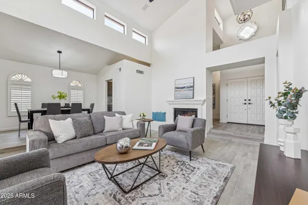 a spacious bedroom with a bed and a chandelier