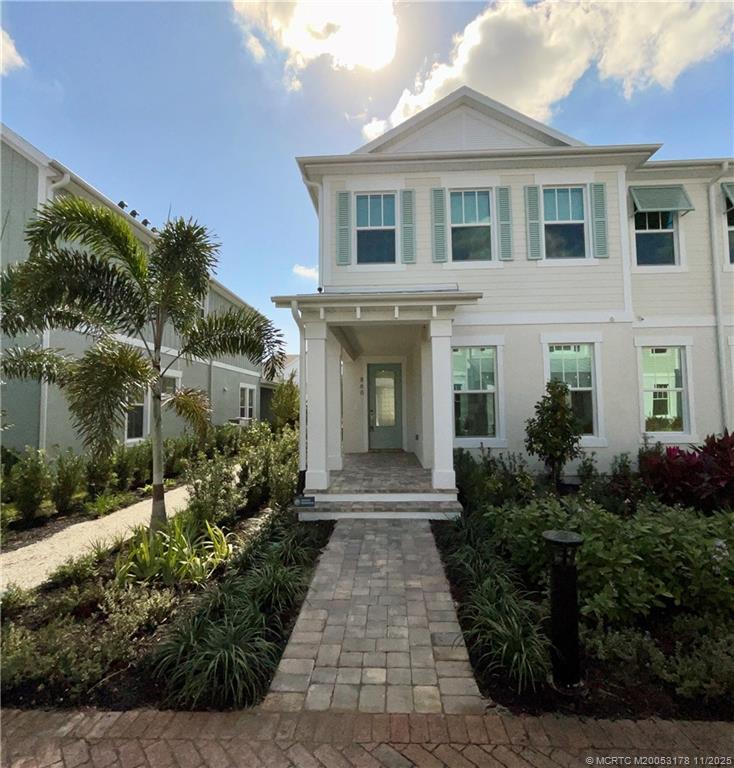 860 Southwest Bushel Trail Palm City, FL 34990 - Photo 1 of 25 a front view of a house with garden