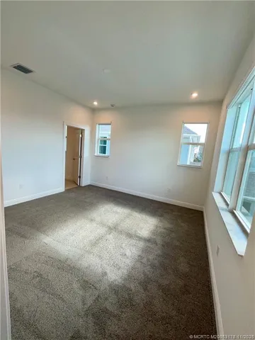 an empty room with windows and entrance