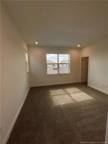 an empty room with a empty space and windows