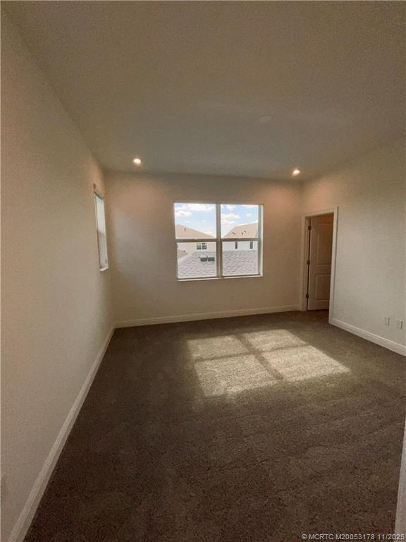 860 Southwest Bushel Trail Palm City, FL 34990 - Photo 12 of 25 an empty room with a empty space and windows