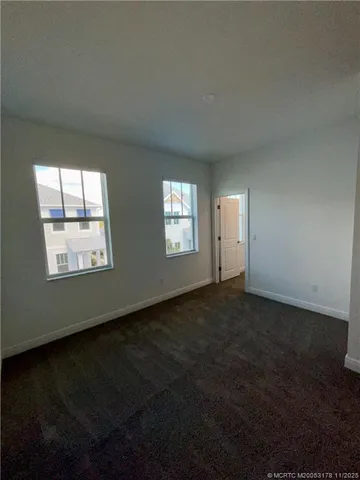 a view of an empty room with windows