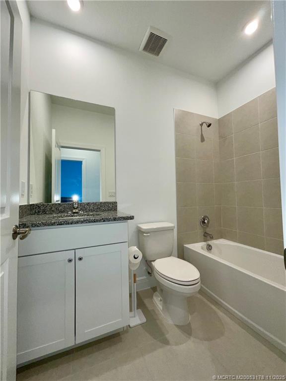 860 Southwest Bushel Trail Palm City, FL 34990 - Photo 20 of 25 a bathroom with a granite countertop toilet a sink and a mirror