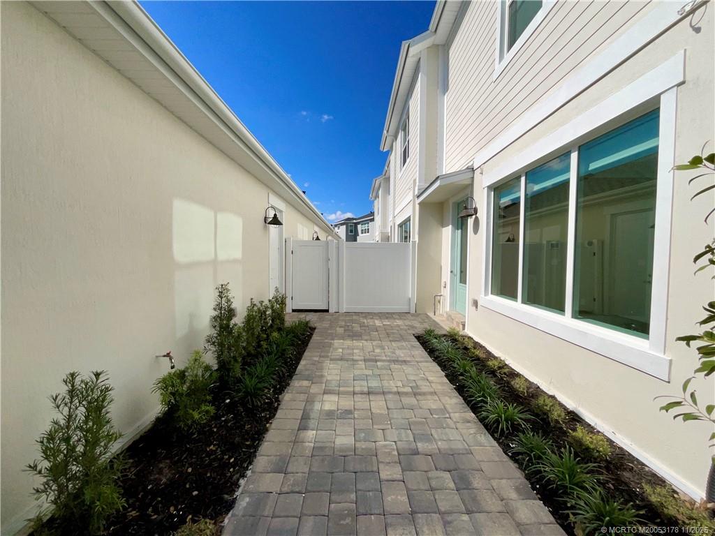 860 Southwest Bushel Trail Palm City, FL 34990 - Photo 2 of 25 a view of a pathway with flower plants