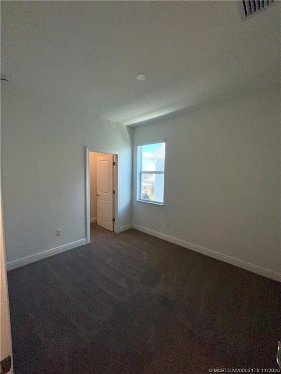 860 Southwest Bushel Trail Palm City, FL 34990 - Photo 22 of 25 an empty room with windows